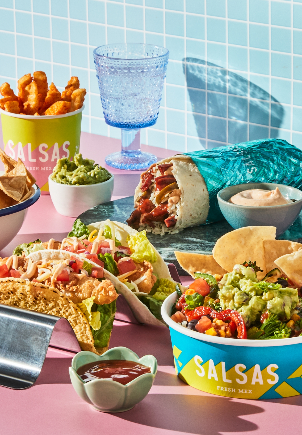 Salsas Fresh Mex spread with a burrito, tacos, corn chips, guacamole and a loaded salad bowl